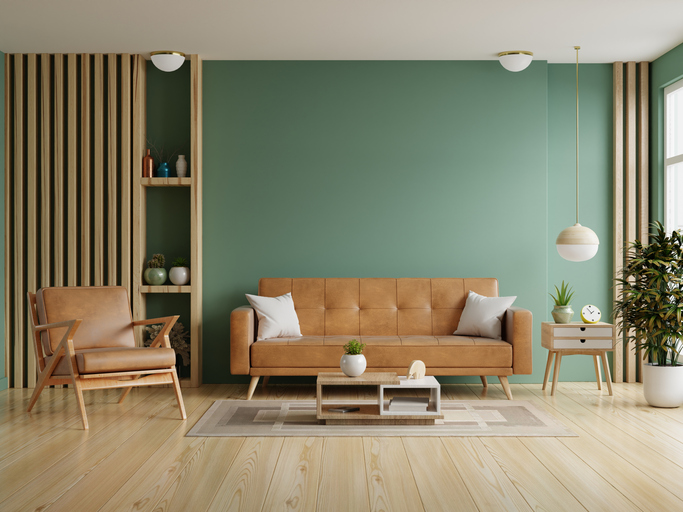 a green interior paint color with a tan couch 