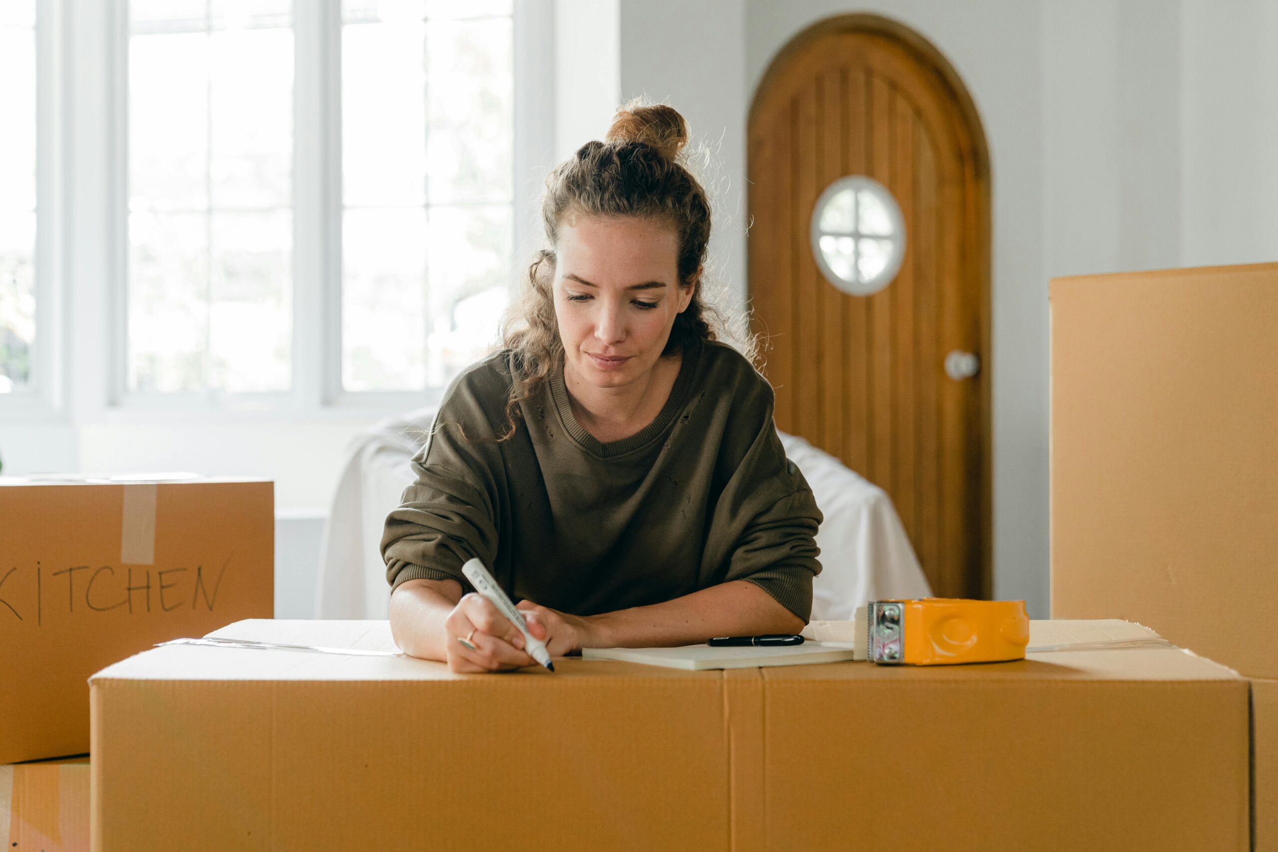 A woman packs up her kitchen for a painting project